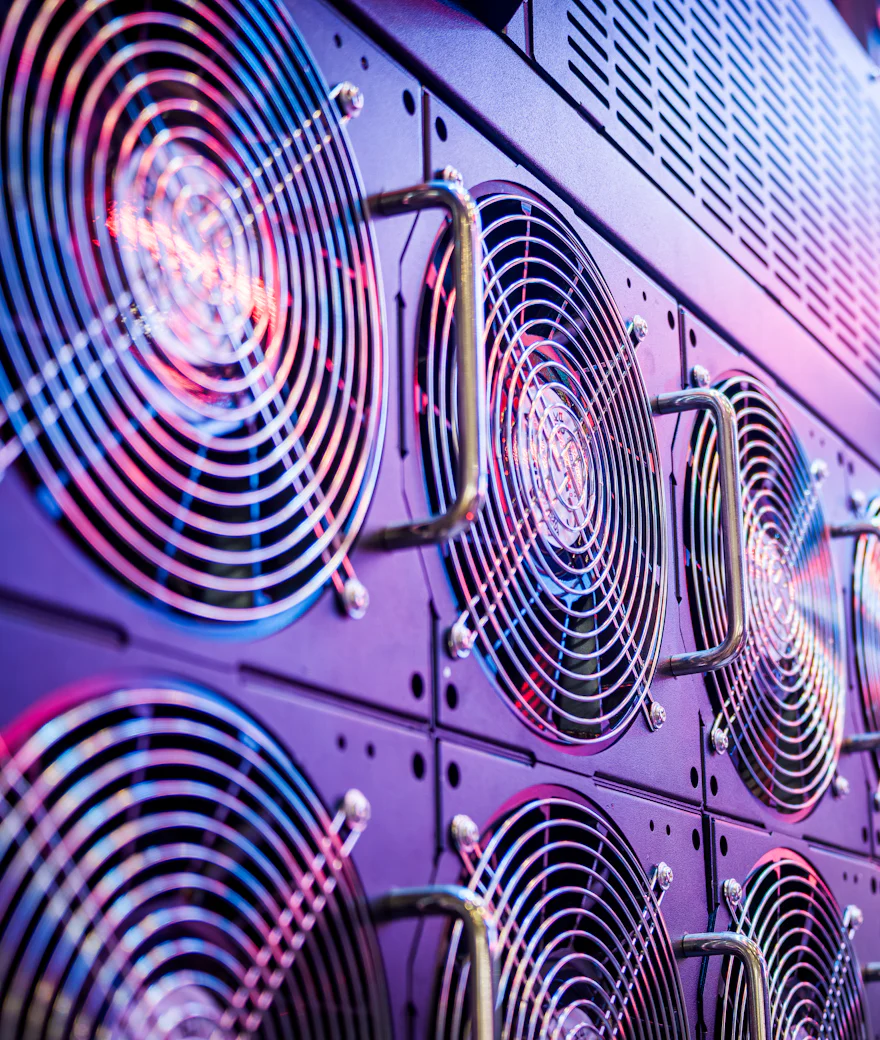 Server cooling fans lit in purple and pink inside a data center
